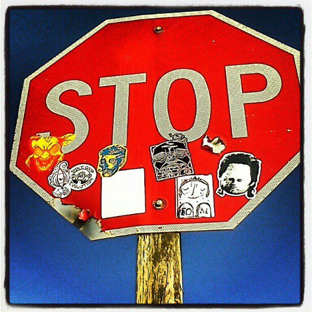 stop sign covered in stickers