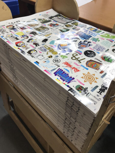 Large stacks of recently printed silkscreen stickers
